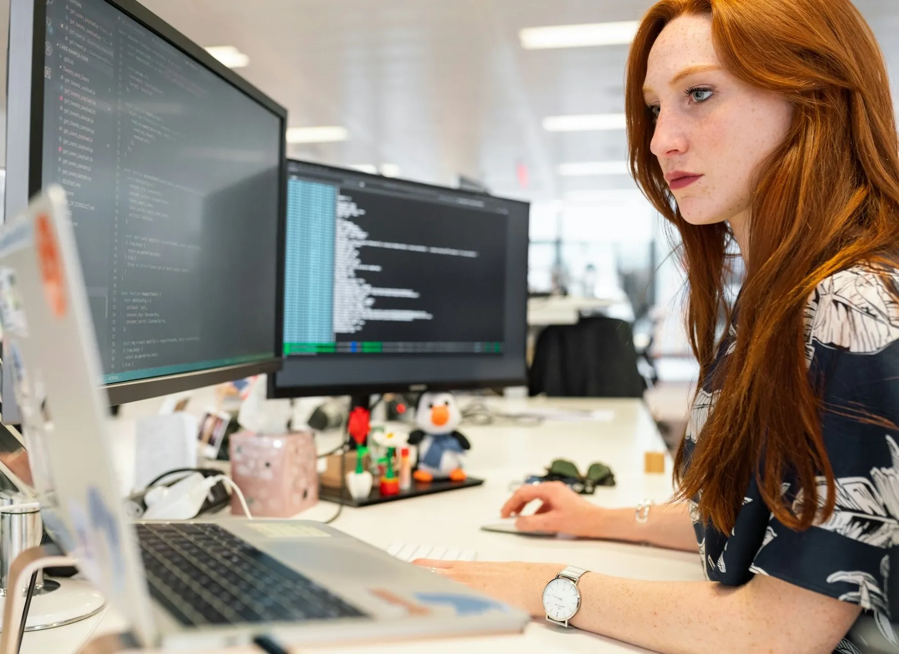 Female engineer sitting in front of workstation.